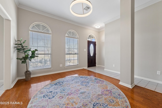 entryway featuring crown molding and hardwood / wood-style floors