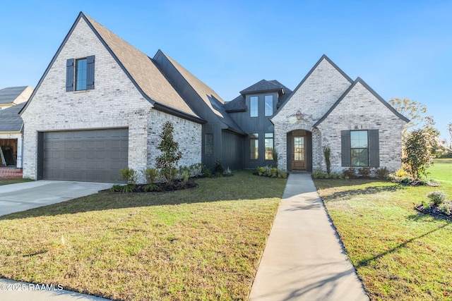 view of front of house with a garage and a front lawn