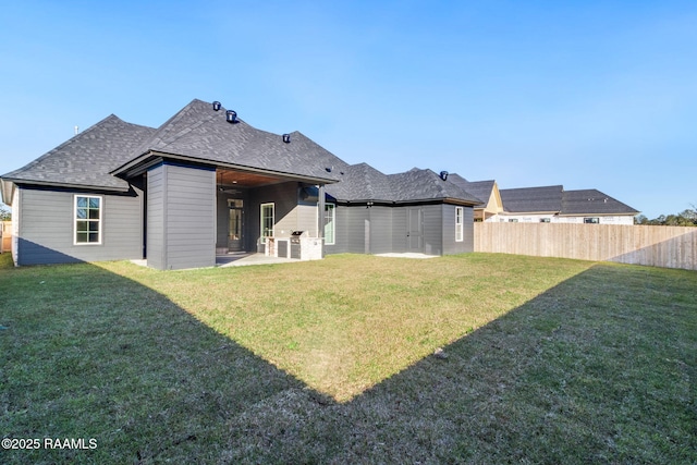 rear view of house with a yard and a patio area