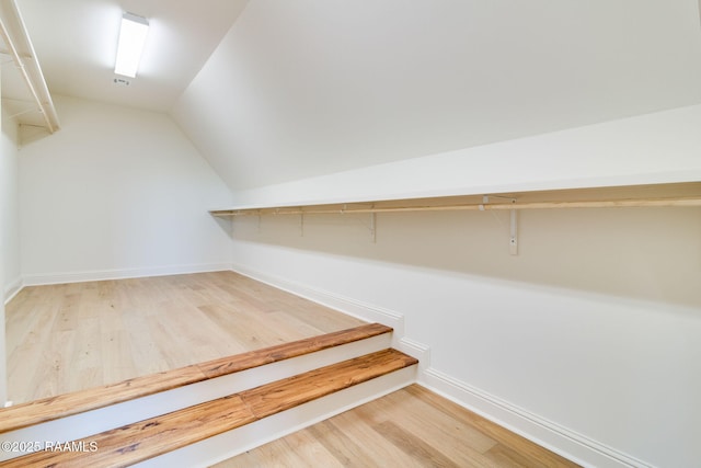 walk in closet featuring lofted ceiling and hardwood / wood-style floors