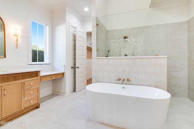 bathroom with vanity and independent shower and bath