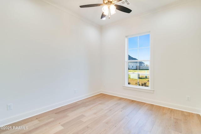 unfurnished room with ornamental molding, ceiling fan, and light wood-type flooring