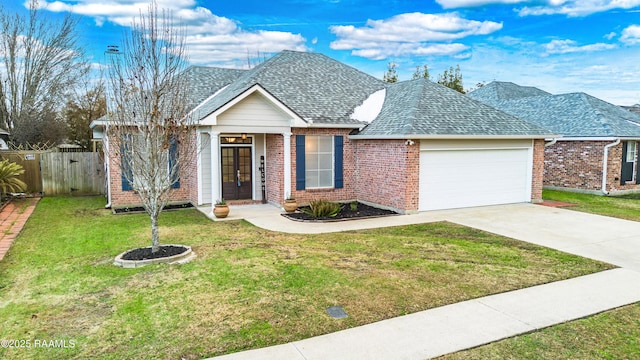 view of front of home featuring a garage and a front lawn