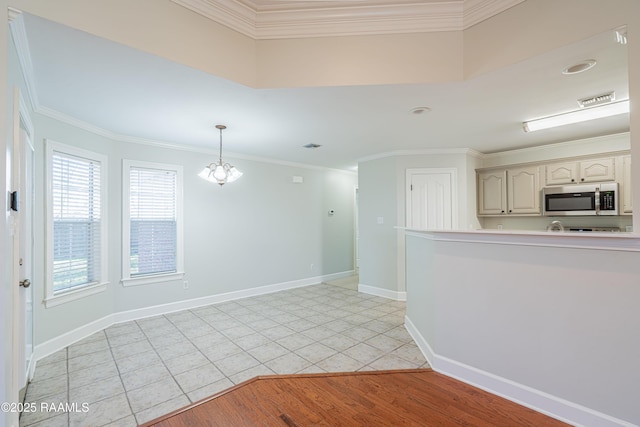 empty room with light tile patterned floors and ornamental molding