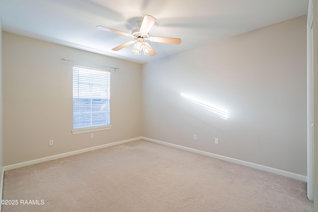 unfurnished room featuring light carpet and ceiling fan