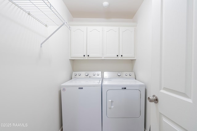 laundry area with cabinets and washing machine and dryer