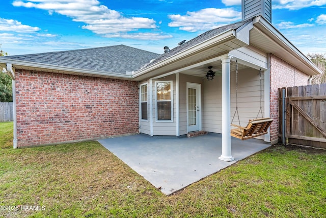 rear view of house featuring a yard, a patio area, and ceiling fan