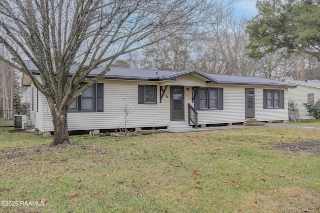 ranch-style home featuring a front lawn and central air condition unit