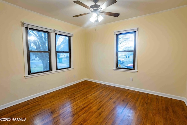 empty room with crown molding, ceiling fan, and dark hardwood / wood-style flooring