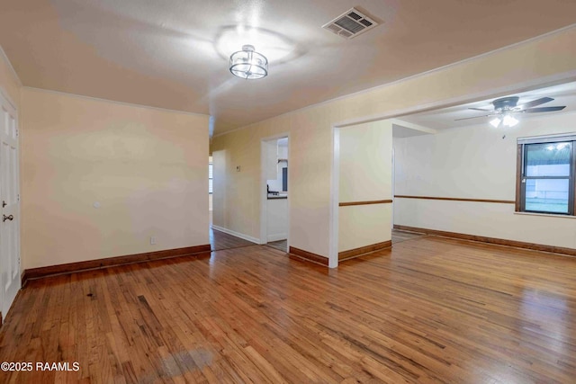 unfurnished room featuring wood-type flooring, ornamental molding, and ceiling fan