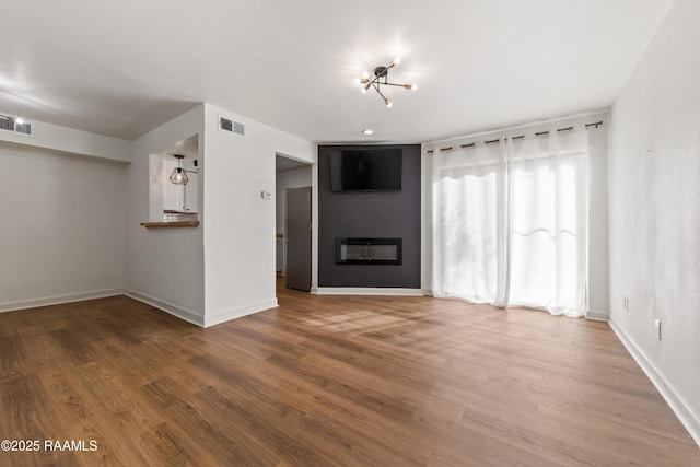 unfurnished living room featuring hardwood / wood-style flooring