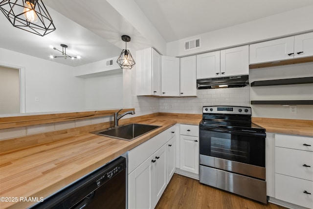 kitchen featuring wood counters, sink, stainless steel range with electric cooktop, hanging light fixtures, and white cabinets