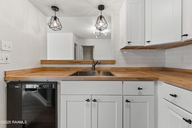 kitchen with butcher block countertops, hanging light fixtures, sink, and dishwasher