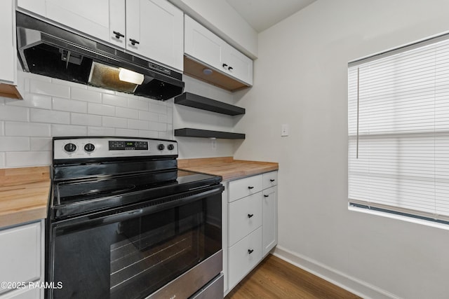 kitchen with wooden counters, dark hardwood / wood-style floors, tasteful backsplash, white cabinets, and stainless steel range with electric cooktop