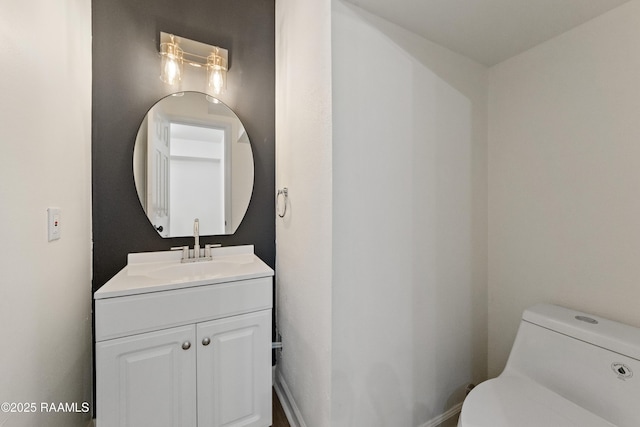 bathroom featuring vanity and toilet