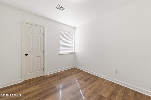 spare room with hardwood / wood-style floors