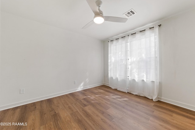 spare room featuring hardwood / wood-style flooring and ceiling fan