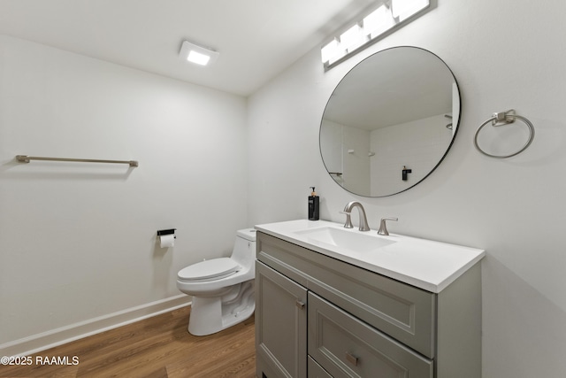 bathroom featuring vanity, hardwood / wood-style floors, and toilet