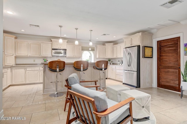 kitchen with decorative light fixtures, a kitchen island, light tile patterned flooring, and appliances with stainless steel finishes