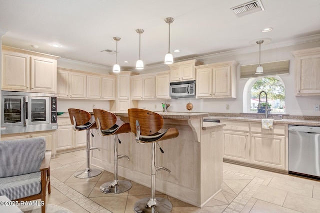 kitchen featuring a center island, appliances with stainless steel finishes, sink, and pendant lighting