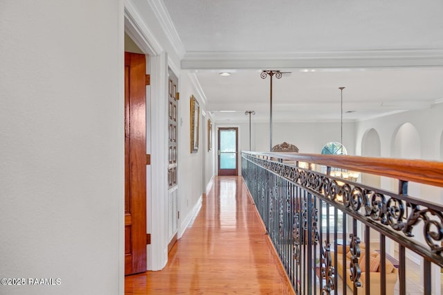 corridor featuring ornamental molding and light hardwood / wood-style floors