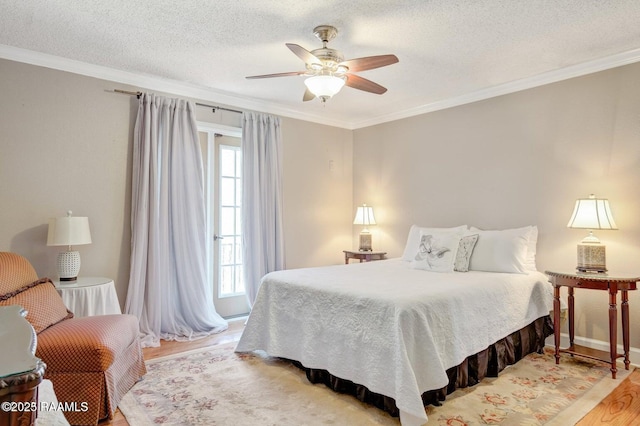 bedroom with multiple windows, ornamental molding, ceiling fan, and light wood-type flooring