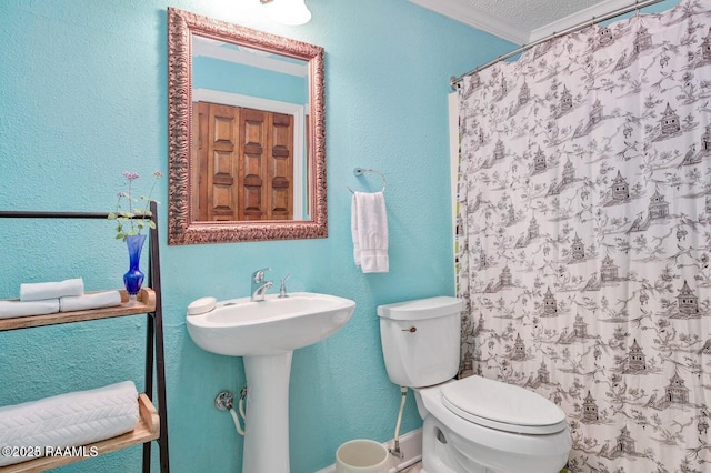 bathroom with sink, crown molding, a textured ceiling, toilet, and walk in shower