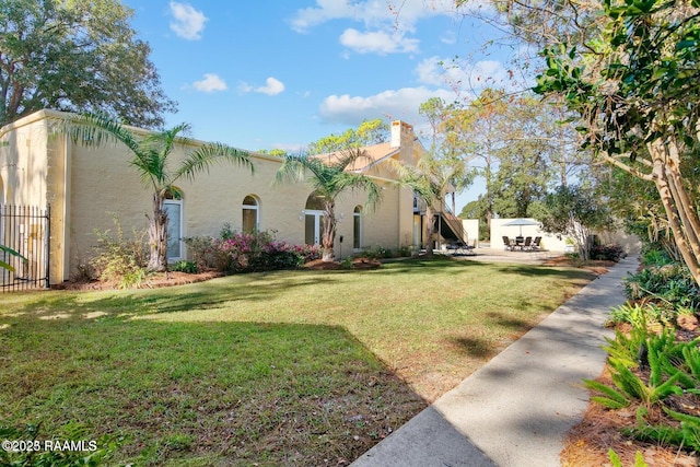 mediterranean / spanish-style house with a patio area and a front yard