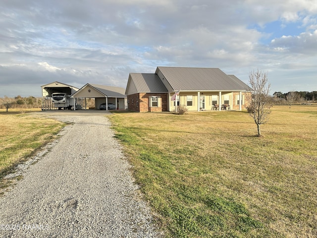 view of front of home featuring covered porch, a carport, and a front lawn