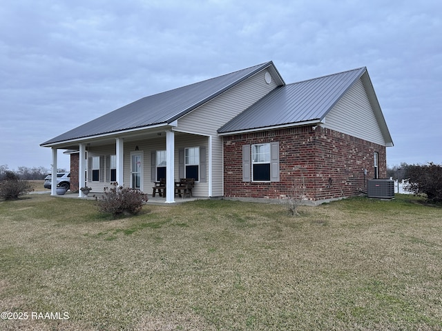 view of front of home with a patio area, central air condition unit, and a front lawn