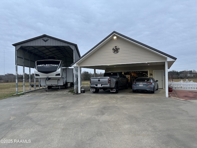 view of parking / parking lot featuring a carport and a garage