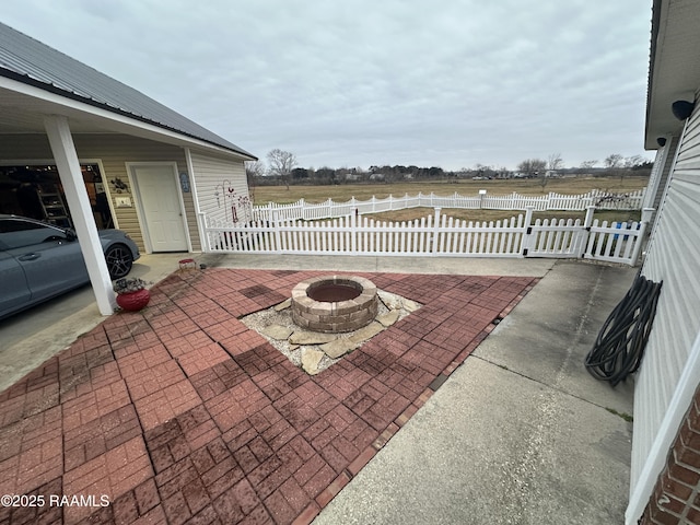 view of patio featuring a fire pit and a rural view