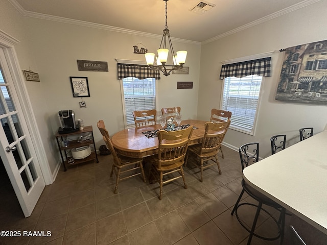 dining room with crown molding, dark tile patterned flooring, and a notable chandelier