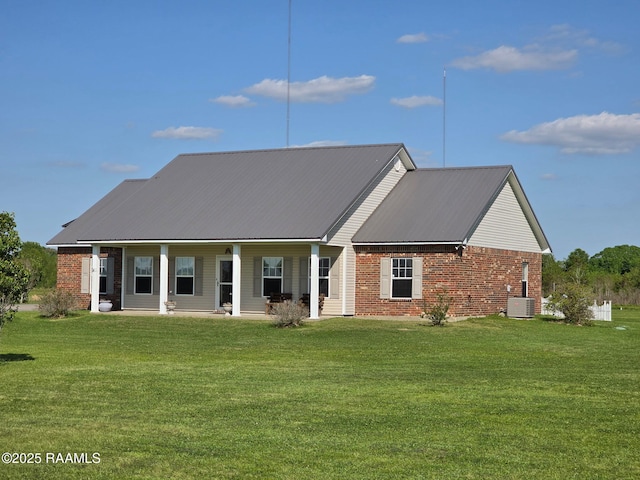 168 Birdhaven Rd, Rayne, LA 70578 - rear view of property featuring brick siding, cooling unit, a lawn, and metal roof