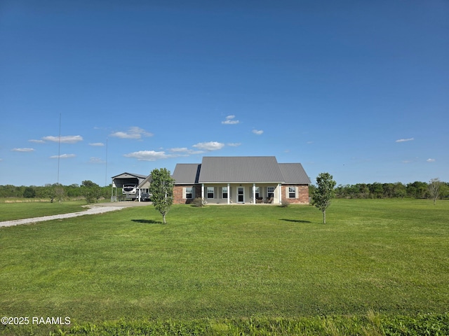 168 Birdhaven Rd, Rayne, LA 70578 - view of front facade with dirt driveway, a front yard, brick siding, metal roof, and a detached carport