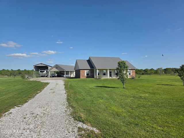 168 Birdhaven Rd, Rayne, LA 70578 - view of front of property with a detached carport, a front yard, driveway, metal roof, and brick siding