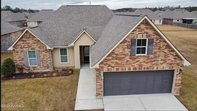 view of front of house featuring a garage and a front lawn