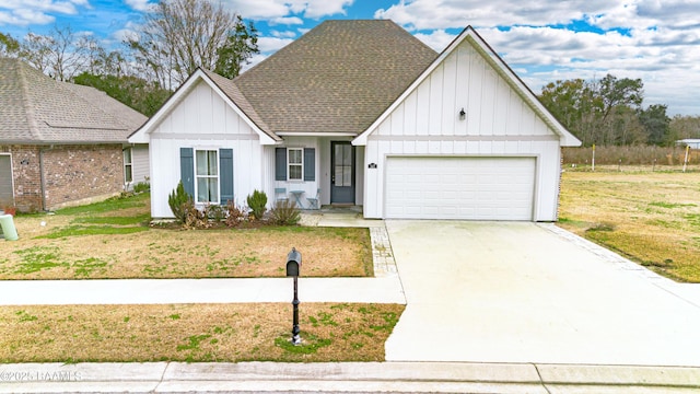 147 Gable Crest Dr, Lafayette, LA 70508 - view of front facade featuring board and batten siding, a garage, driveway, a shingled roof, and a front lawn