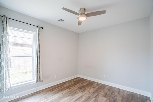 empty room featuring hardwood / wood-style flooring and ceiling fan