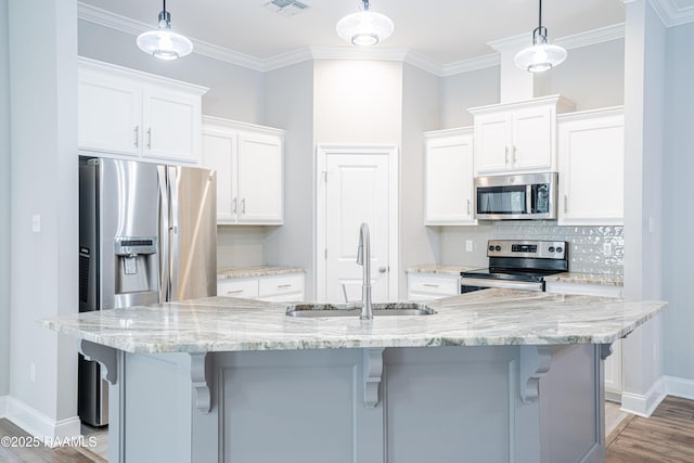 kitchen featuring sink, decorative light fixtures, stainless steel appliances, and white cabinets