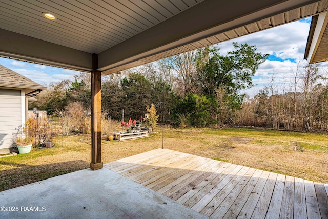 wooden terrace with a lawn and a patio