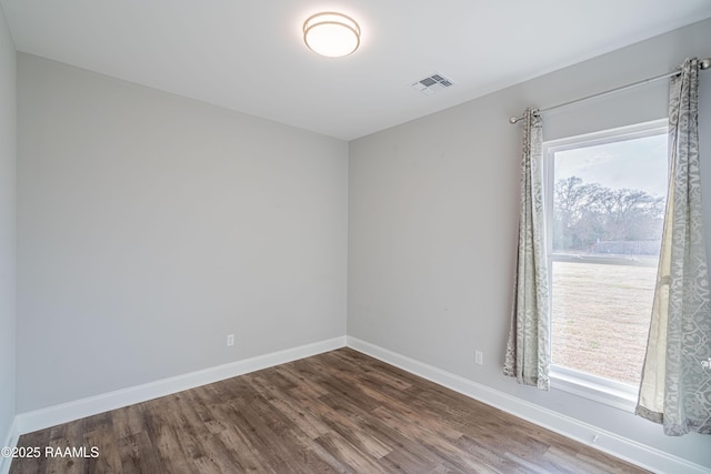 unfurnished room with hardwood / wood-style floors