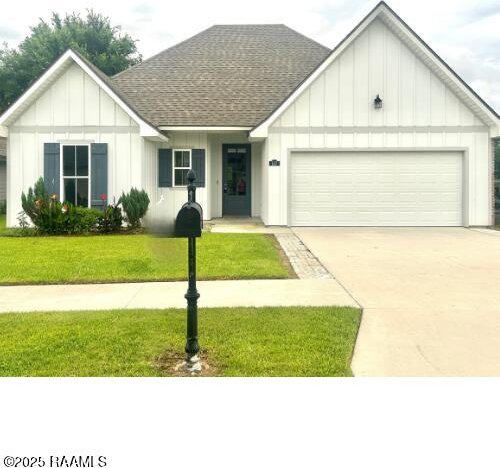 147 Gable Crest Dr, Lafayette, LA 70508 - view of front of house featuring a garage, roof with shingles, concrete driveway, a front lawn, and board and batten siding