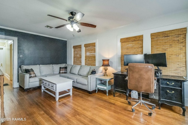 living room featuring crown molding, ceiling fan, and wood-type flooring