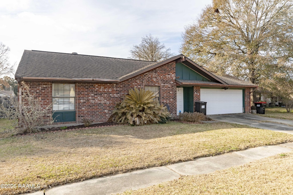 ranch-style house with a garage and a front lawn