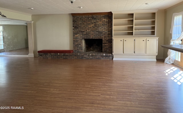 unfurnished living room featuring plenty of natural light and dark hardwood / wood-style floors