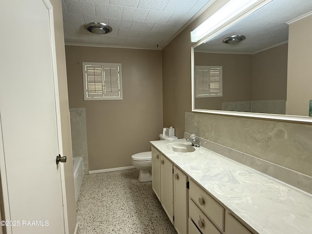 bathroom featuring vanity, toilet, crown molding, and a tub to relax in