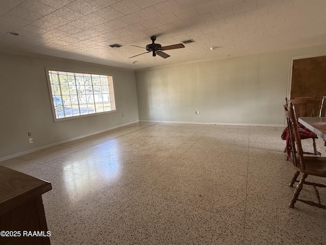 empty room featuring crown molding and ceiling fan