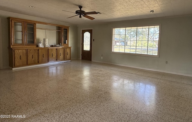 interior space with crown molding and ceiling fan