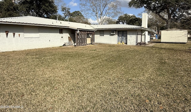 ranch-style home featuring a storage shed and a front yard